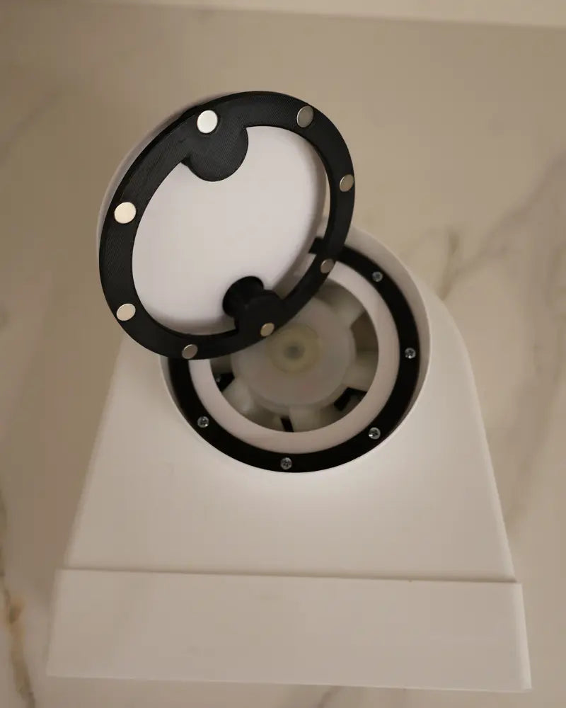 Close-up of minimalist round vent grille, paintable matte finish