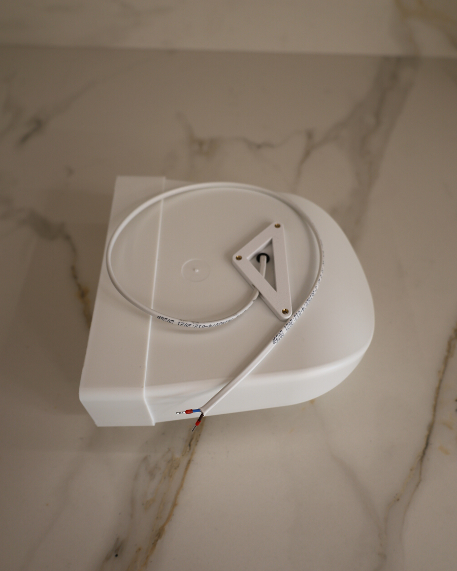 Top view of GRATKA SLIM 125 housing with power cable and flat 60x204 mm duct outlet for drywall installation