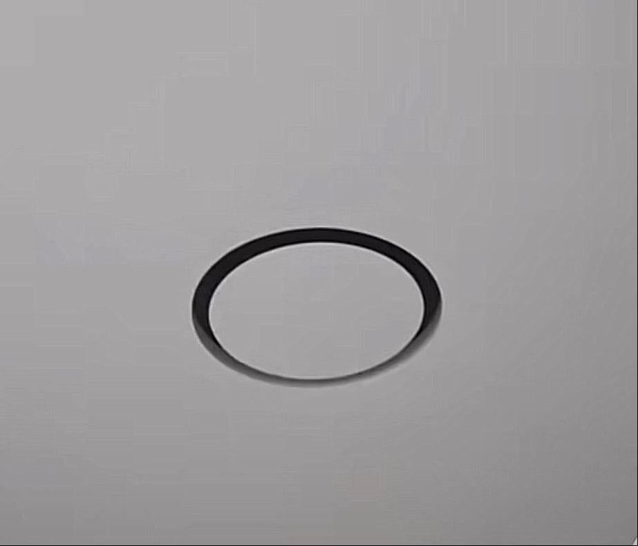 Installed GRATKA SLIM 125 fan, only thin black ring visible flush in white stretch ceiling, hidden ventilation