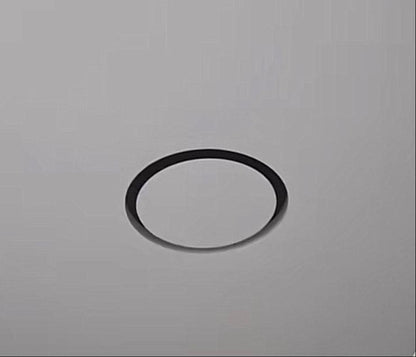 Installed GRATKA SLIM 125 fan, only thin black ring visible flush in white stretch ceiling, hidden ventilation